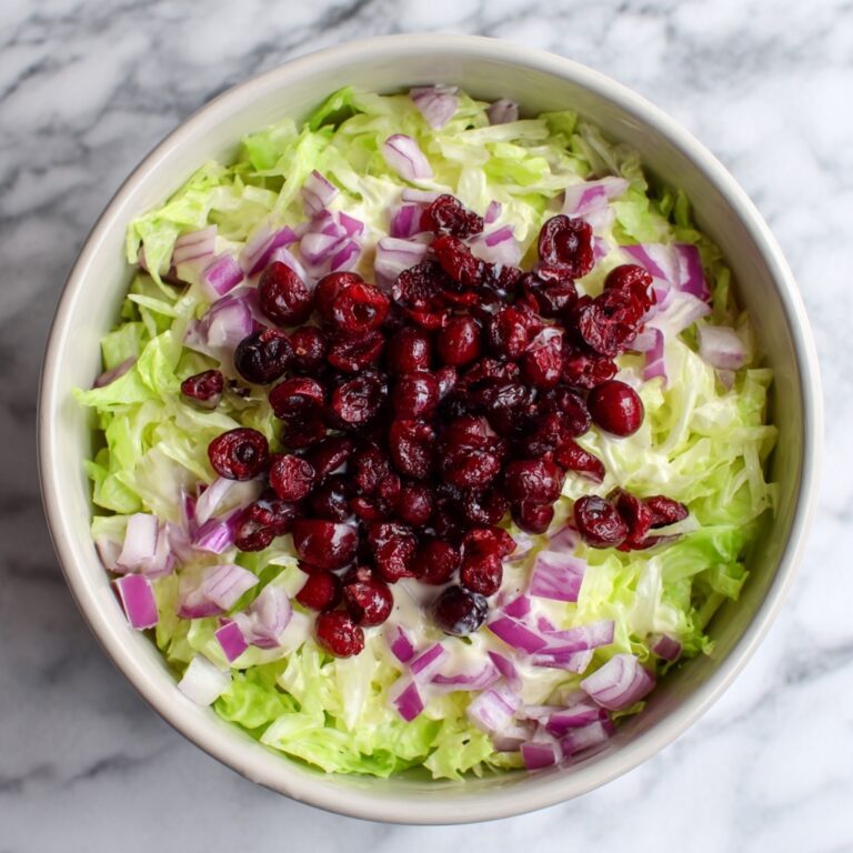 Creamy Brussels Sprouts Slaw with Cranberries, Parmesan, and Orange-Honey Dressing Recipe